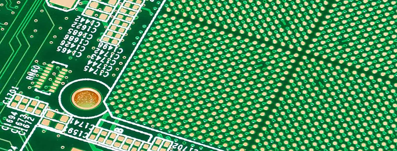 Close-up of a green circuit board with BGA pads